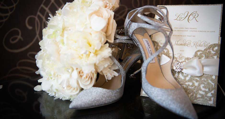 Invitation, bouquet and wedding shoes shot. 