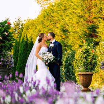 Bride and Groom kissing in Larkfields garden.