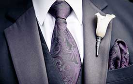 Mens wedding suit with purple tie.