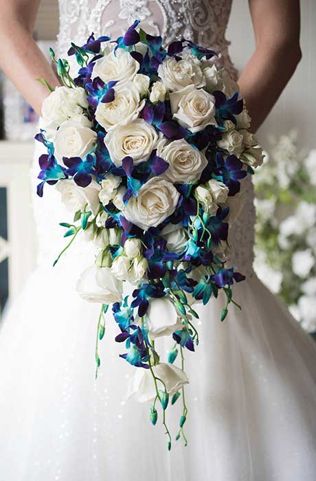 A close up photo of the brides blue and white wedding bouquet.