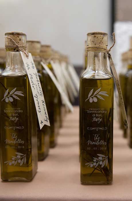 Multiple bottles of olive oil as guest's favors.