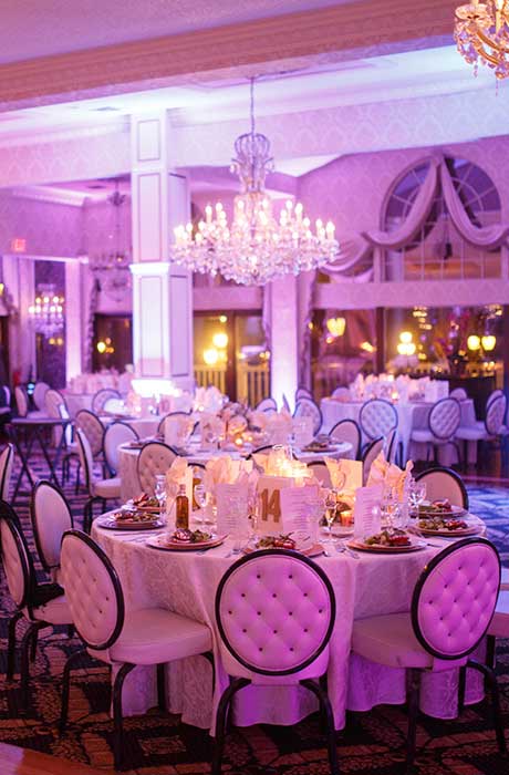 Reception room set up with pink up lighting. 