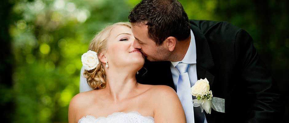 Close up of bride and groom kissing. 