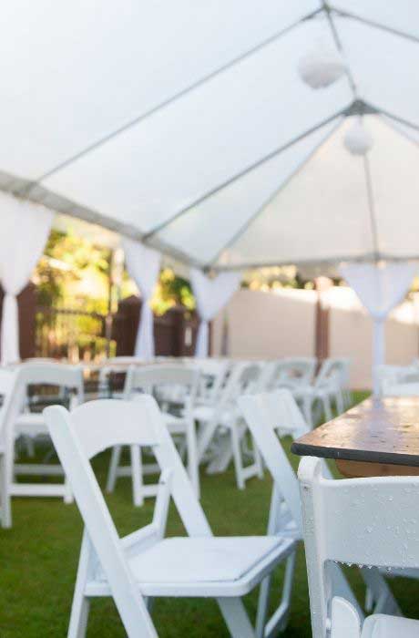 An example of tables and chairs under a tent at a micro wedding.
