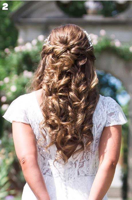 Bride with curled half up half down wedding hairstyle.