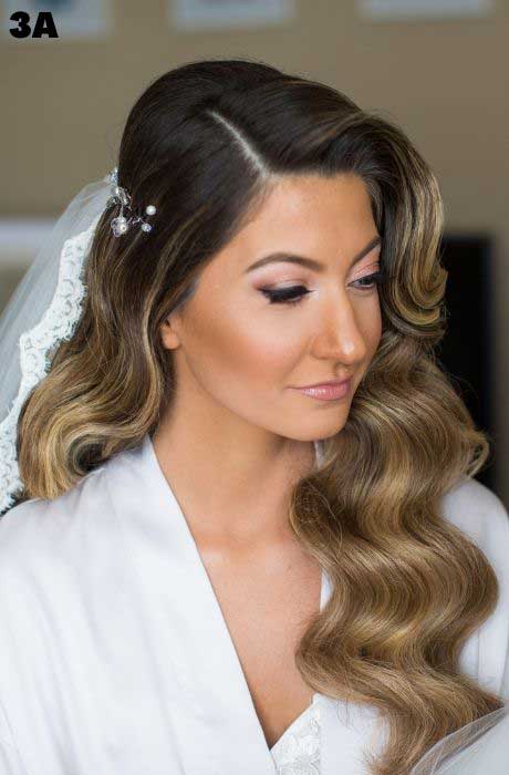 Bride with voluminous curls and wavy hairstyle.