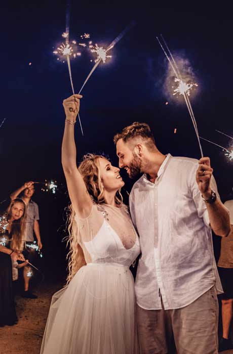 bride and groom holding sparklers wedding traditions
