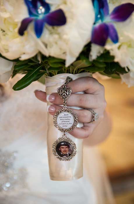 bride holding her bouquet with family photo charm 