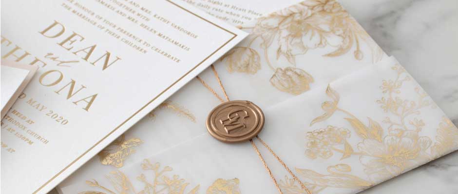 White and gold foil stamped invitations by Giant Invitation.