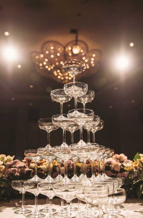 Champagne tower glasses at wedding reception. 