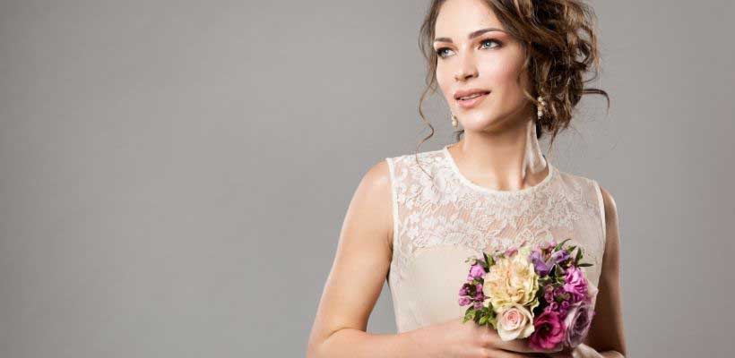Bridal wedding makeup, bride holding flowers. 