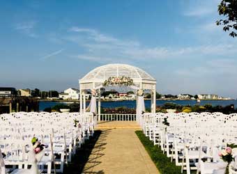 Outdoor ceremony setup with chairs overlooking the water. 